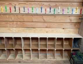 On the opposite wall, boot cubbies & coat hooks
