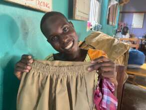 A learner displays her practice output with smiles