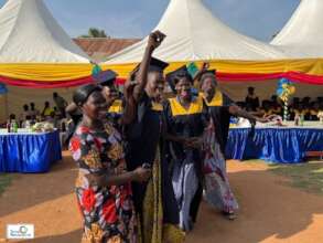 A graduate jubilates with a relative