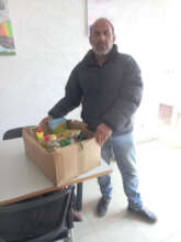 Muharrem receiving his monthly food package