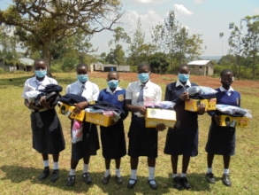Girls receiving new school uniforms