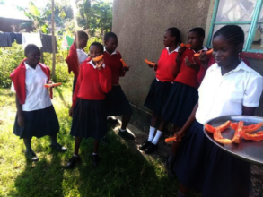 Girls enjoying papaya from school farm