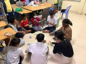 A volunteer teacher and students are hanging out