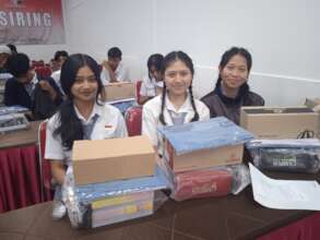 Girls in Gianyar posed with their school supplies