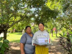 Rosita and her mother receiving school supplies