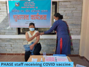 PHASE Nepal auxiliary midwife receiving vaccine