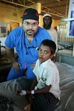 Dr. Aziz with patient after surgery