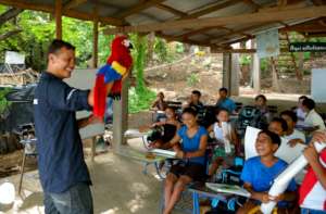 A ranger & Macaito the macaw teach local children