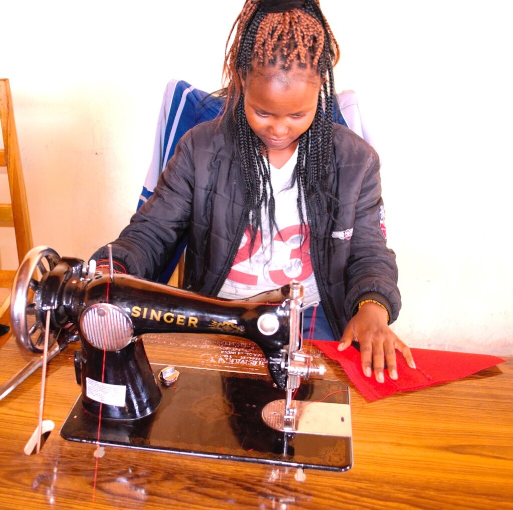 A woman using a sewing machine during training