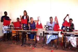 Women showcasing their first item in sewing
