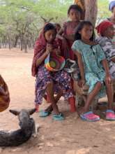 Community girl Weaving a mochila