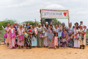 artisans in front of the community orchard