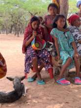 Community girl weaving a backpack
