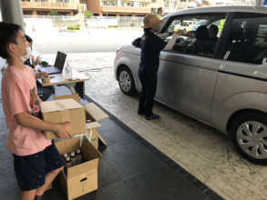 Youth Delivering Food at Naha Drive Thru