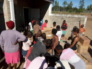 children excited with gifts from friends & Donors