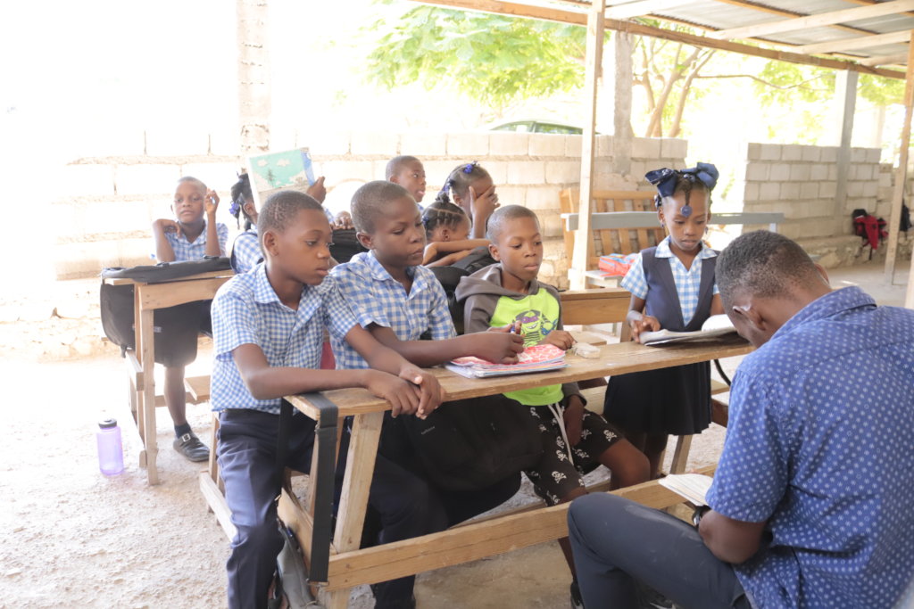 Students listen to a lecture at Source Divine