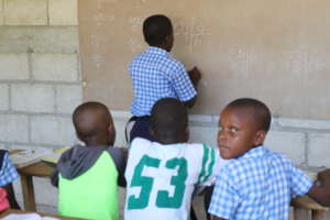 Student at Source Divine  Working on Math