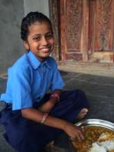 Student of bridge school enjoying her school lunch
