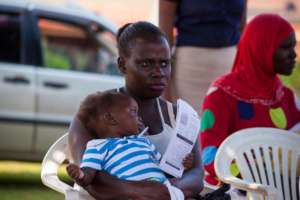 A mother attending an immunisation clinicc