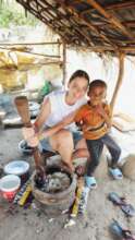 Happy child with help of the volunteer, Kate
