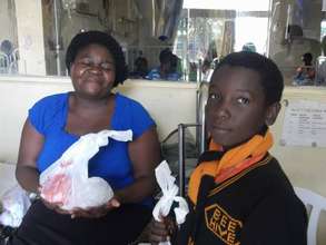 BeeHive student giving donation to patient