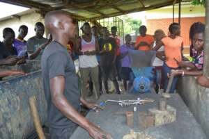 Interns are taught the briquette making process