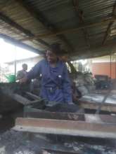 A woman undergoing training at the briquette unit