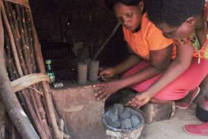 A lady lights up her briquettes
