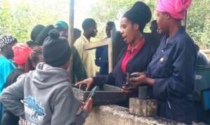 Interns practicing briquette making