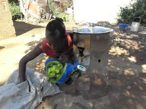 Tasila, a sixth grader, helping with the stove