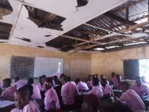 Students in classroom with damaged ceiling