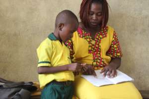Boy returns to school after Ebola outbreak.