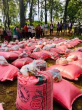 Jungle community members gather for relief items.