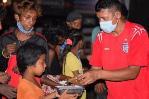 Street children receiving pre-packaged meals.