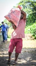 A man takes a sack of rice to bring to his family.