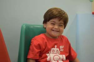 Child expressing happiness on a usual day at KDSP