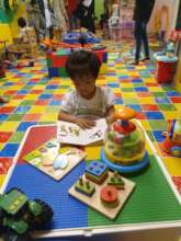 Kid engaging with learning tools at a cafe