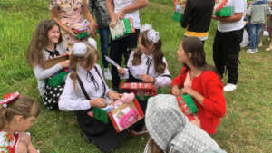 Displaced Ukrainian children opening gifts