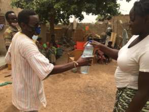 BARKA staffer delivers soap and sensitization