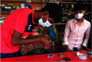 Jahangir learning how to repair a mobile phone.