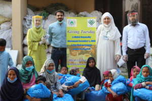 volunteers and children with their clothes