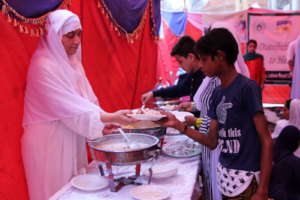 chairperson serving meal to homeless children