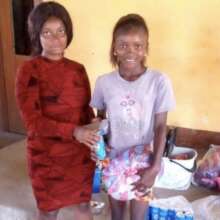 Samuella dietributing gifts to Makeni Child