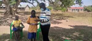 Daniel receiving books and pens