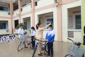 Students receiving bikes and helmets