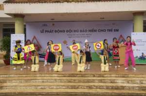 Gia Lai students celebrate the new helmet program.