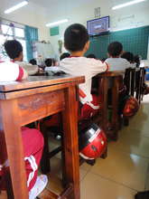 Kids in class with helmets at their sides