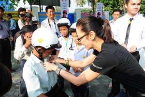 Michelle Yeoh Fitting Helmet on Student