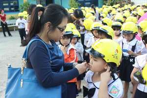 AIP Foundation teaches a child how to use a helmet