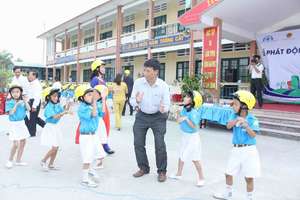 Students celebrate their new helmets with a dance